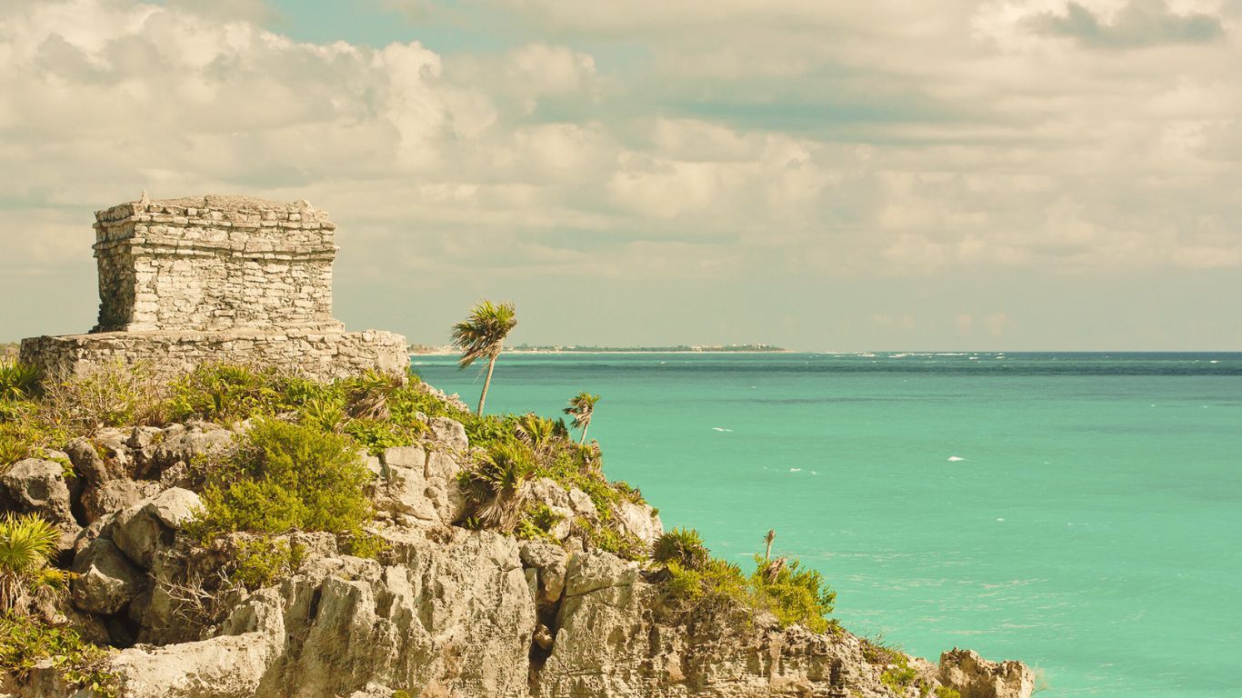 A view to Tulum's beach from behind mayan ruins.